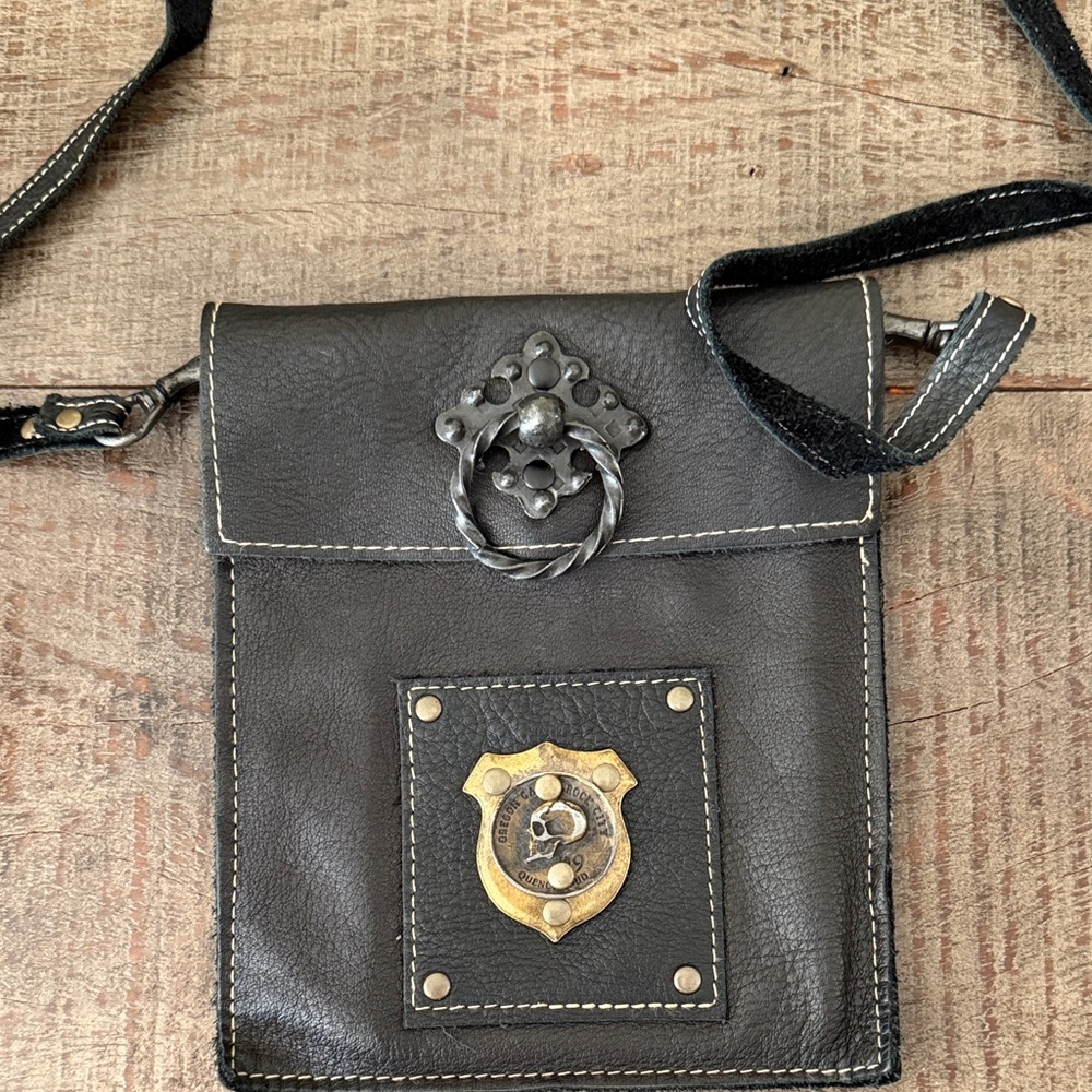Black Leather Crossbody with Decorative Metal Badge